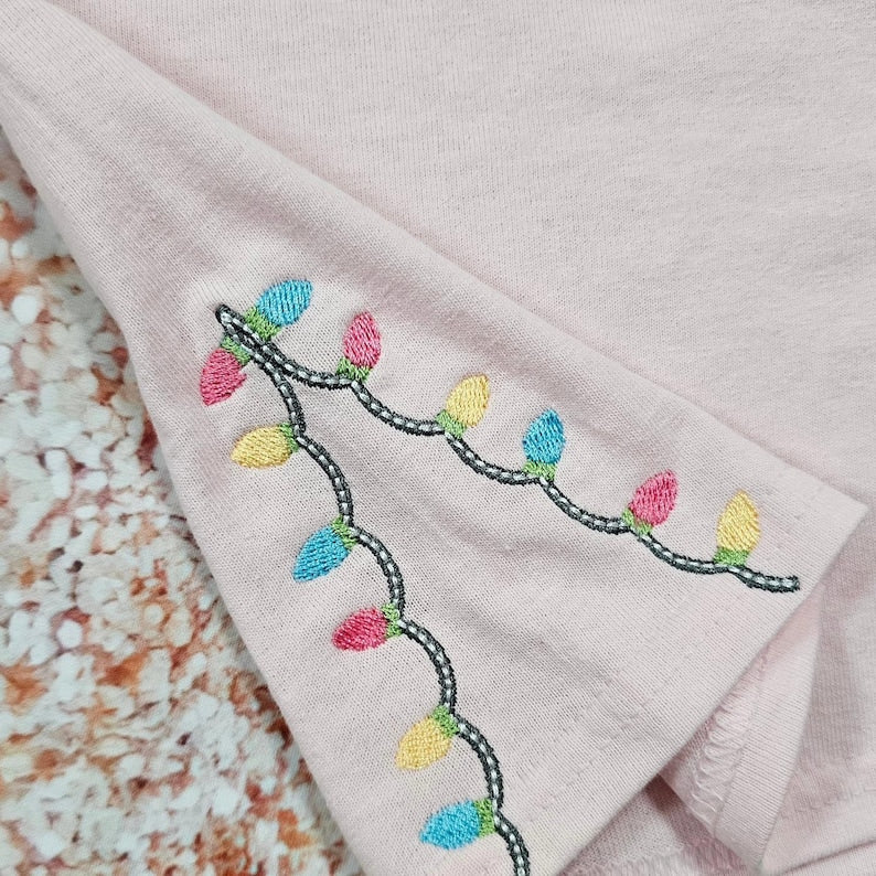 Pastel Nutcracker Christmas T-Shirt with Embroidered Christmas Lights - Side Slit Detail Embroidery - Pastel Christmas